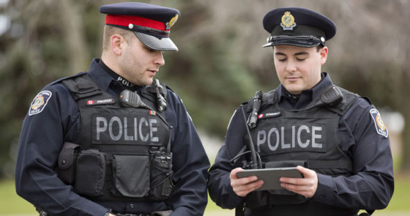 Two public safety officers using analytics tool