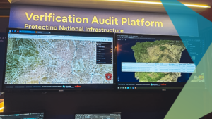 Screen showing Fujitsu and Hexagon's solution with a blue sign sign with white text saying "Verification Audit Platform"
