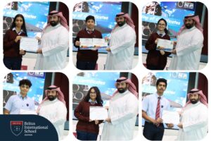 BRS-Labs students being awarded certificates by their male teacher. There is a logo that says "Britus International School Bahrain" in white text on a blue background.